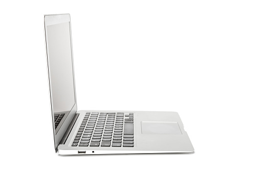 Side view of gray laptop with blank screen on white background