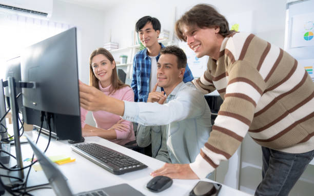Group of employees brainstorming and teamwork in office.