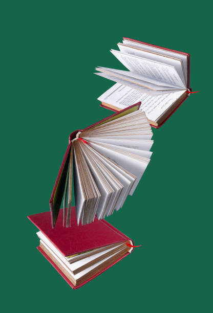 red-bound books fly on a green background