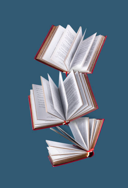 istock books in red cover fly on a blue background 1456391078
