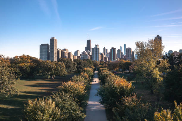 Fantastic Chicago skyline aerial drone photograph above Lincoln Park with a tree lined walkway centered on a sunny blue sky autumn day. stock photo