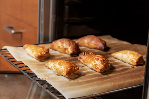 Puff pastry stuffed with cabello de angel or pumpkin candy on the grill of an oven after having baked them.