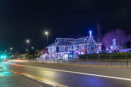 NEWCASTLE UPON TYNE, United Kingdom – December 29, 2022: The 'Daft As a Brush' cancer patient transport charity's building lit up for Christmas 2022 in Gosforth, Newcastle upon Tyne, UK