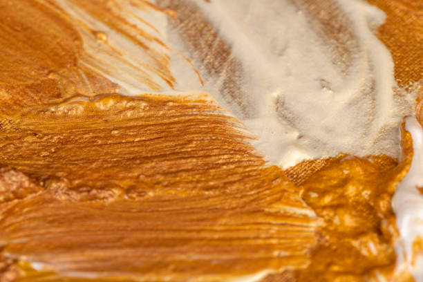 Abstract chaotic painting on canvas with gold paints, using gold-colored paints and gold shades for creative work