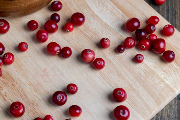 Red ripe cranberries harvested in swamps, freshly harvested wild sour cranberries of small size