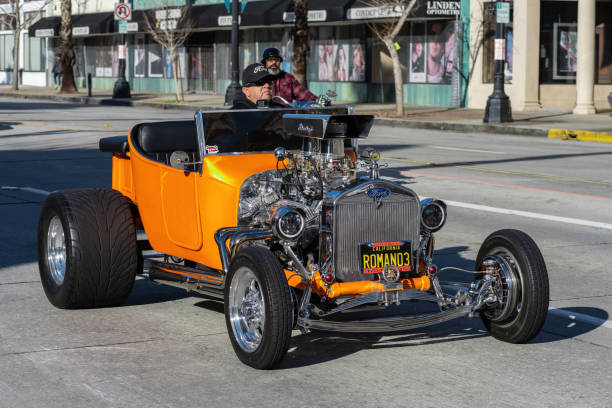 Ford Hot Rod Driving Pasadena, California, United States: Hot rod car shown cruising on Colorado Boulevard in the City of Pasadena on New Year's Day. cruising hot rods stock pictures, royalty-free photos & images
