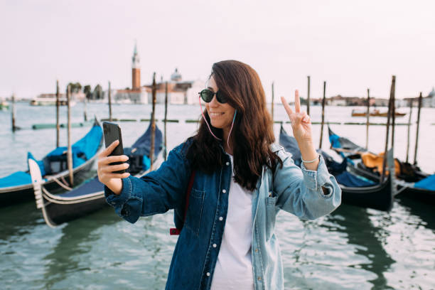istock Female tourist having selfie with her phone 1456413280