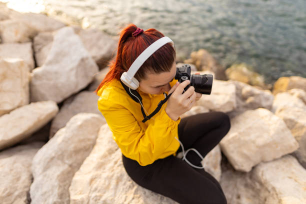 istock Woman photographing on the beach 1456415485