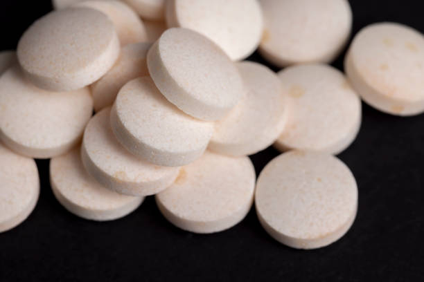istock White and yellow medical medicines on a black background 1456417356