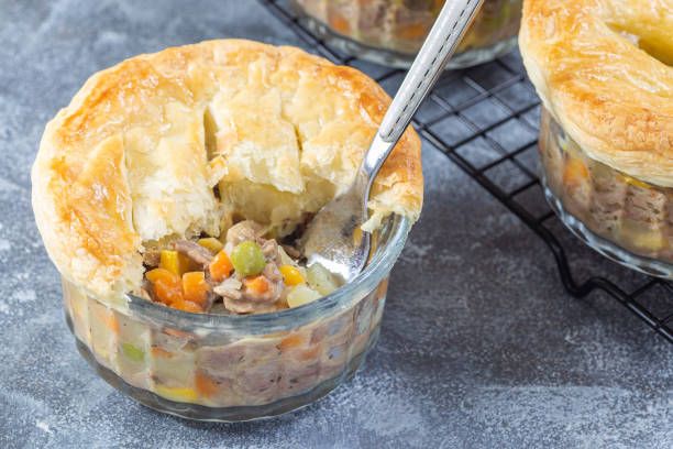istock Individual beef pot pie or deep dish pie in ramekin, crust broken open to show the inside 1456417598
