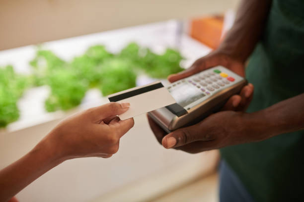 istock Woman Paying for Groceries 1456420365