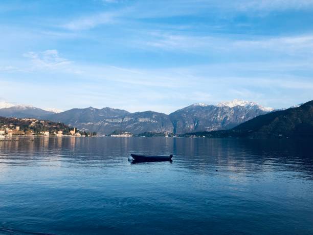 istock Lonely boat on blue lake 1456420862