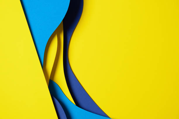 istock Abstract colored paper texture background. Minimal paper cut composition with layers of geometric shapes and lines in light blue, navy blue, yellow colors 1456425315