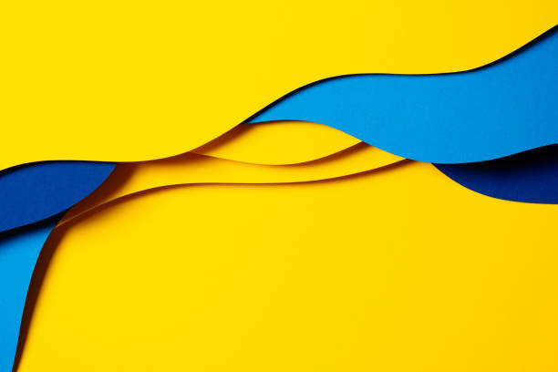 istock Abstract colored paper texture background. Minimal paper cut composition with layers of geometric shapes and lines in light blue, navy blue, yellow colors 1456425377
