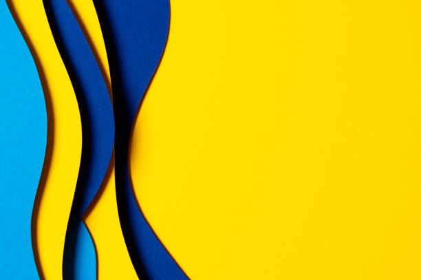 istock Abstract colored paper texture background. Minimal paper cut composition with layers of geometric shapes and lines in light blue, navy blue, yellow colors 1456425381