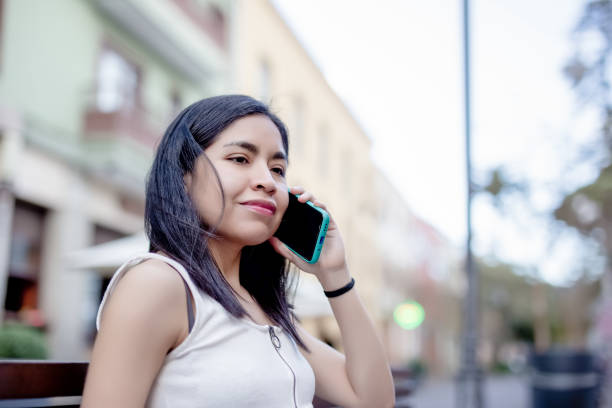 istock asian woman using a mobile phone in the city 1456426052