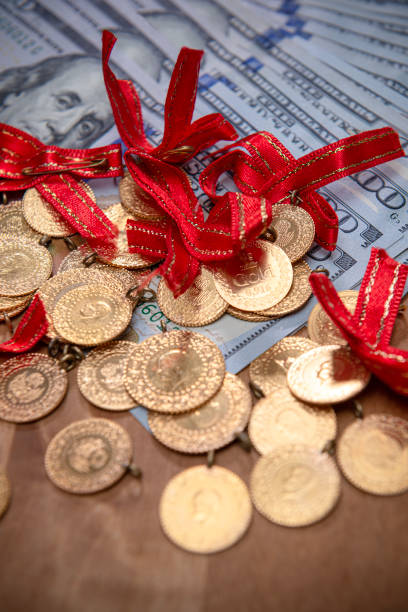 istock Turkish gold coins over US dollar bills. 1456426378