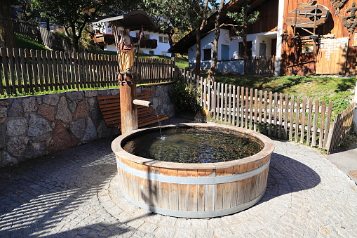 a wooden well with an old water pump