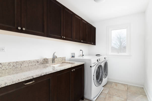 istock A laundry room with wood cabinets and white appliances. 1456429465