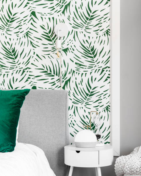 istock A bedroom nightstand detail in front of a patterned wallpaper. 1456429510