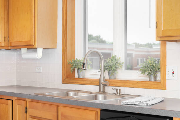istock A kitchen sink faucet around wood cabinets. 1456429542