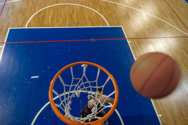 istock Man in wheelchair practicing basketball 1456429546
