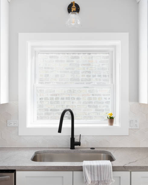 istock A white kitchen detail with a black faucet and hexagon backsplash. 1456429568