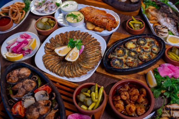 istock Fish table, anchovies, trout, cod, shrimp, squid and salad varieties 1456430120