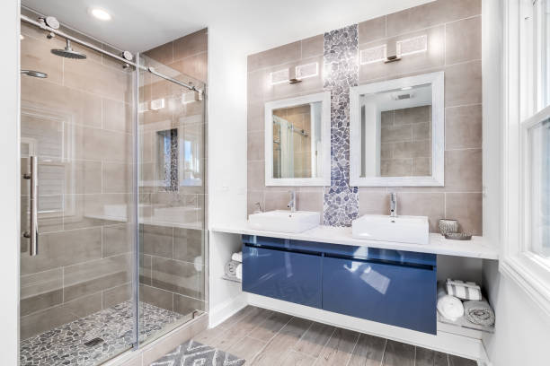 istock A modern bathroom with a blue floating cabinet and brown tiled shower. 1456430129