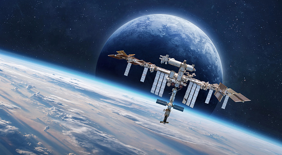 International Space station on orbit of Earth. Space wallpaper with ISS and planet surface. Astronauts in space. Elements of this image furnished by NASA (url:https://www.nasa.gov/sites/default/files/styles/full_width_feature/public/thumbnails/image/iss066e123388.jpg https://www.nasa.gov/sites/default/files/styles/full_width_feature/public/thumbnails/image/iss066e080432.jpg https://earthobservatory.nasa.gov/blogs/elegantfigures/wp-content/uploads/sites/4/2011/10/land_shallow_topo_2011_8192.jpg )