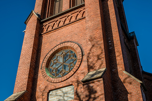 Trollhättan, Sweden - October 08 2022: Detail of curch tower at Trollhattan church.