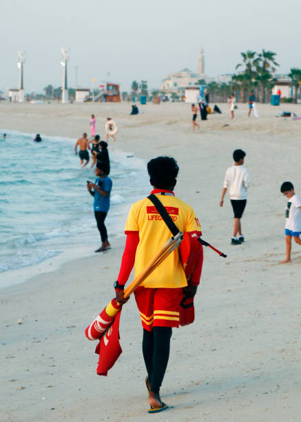 lifeguard walk around to ensure the safety in a beach - lifeguard association imagens e fotografias de stock