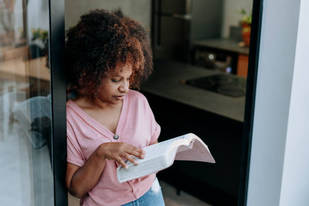 istock Woman reading the bible 1456438442