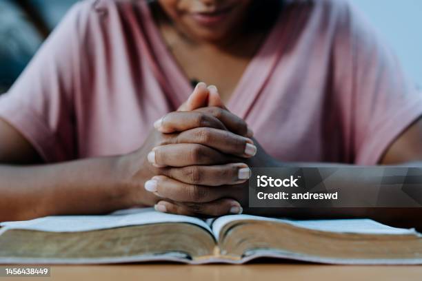 Woman Praying With The Bible On The Table Stock Photo - Download Image Now - Praying, Women, Bible