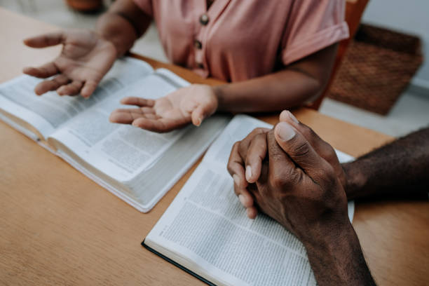 istock Couple praying together 1456438484