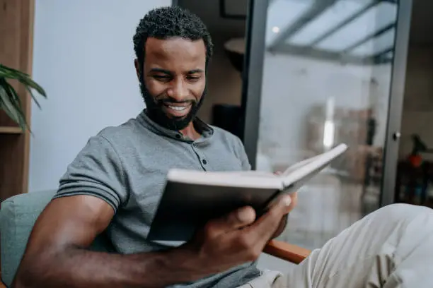 Photo of Man reading the bible