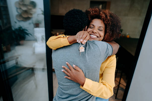 Ecstatic couple holding keys to new home