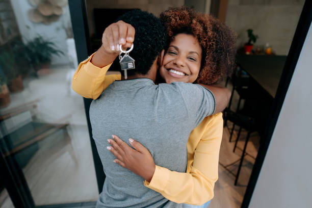 istock Ecstatic couple holding keys to new home 1456438557