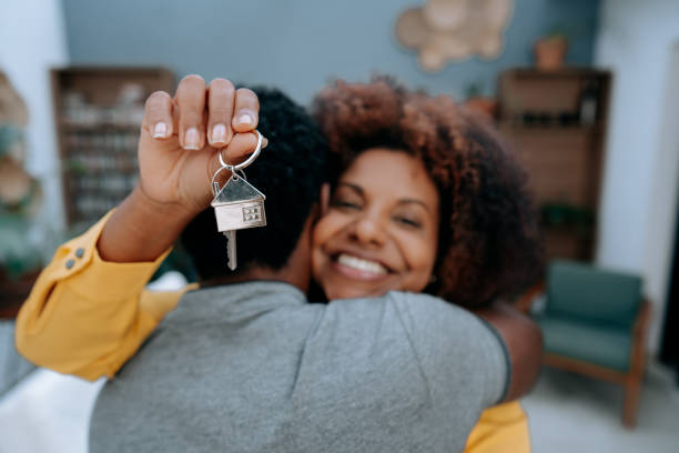 istock Couple with keys to new house 1456438563