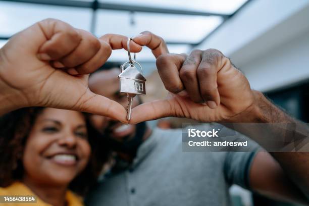 Couple Second Key To New Home With Hand In Heart Symbol Stock Photo - Download Image Now