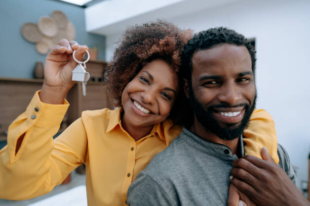 istock Couple with keys to new house 1456438565