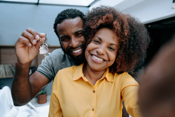 istock Ecstatic couple making selfie in new house 1456438573