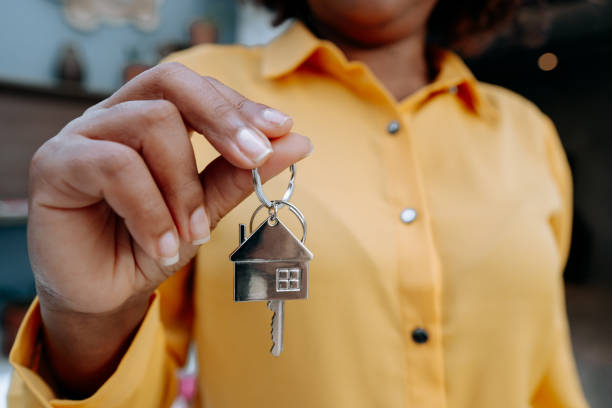istock Real Estate Agent holding house key 1456438577