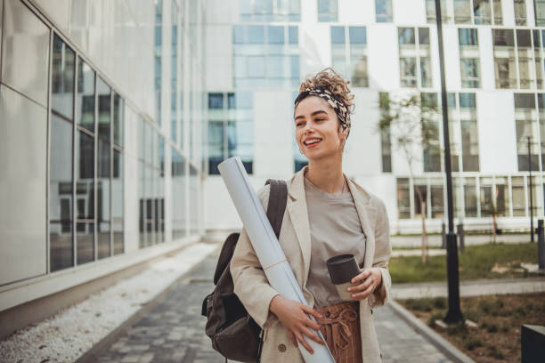 Portrait of a female student standing next to the faculty building stock photo