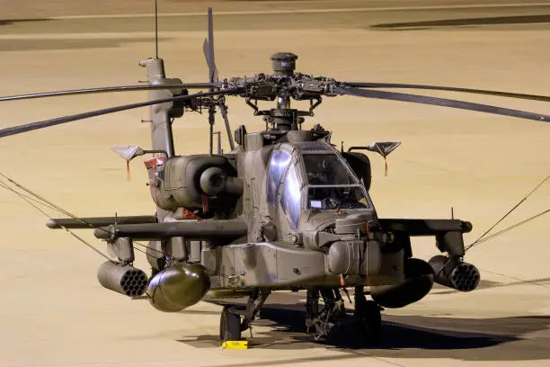 US Army Boeing AH-64E Apache Guardian attack helicopter on the tarmac during a nightstop at Eindhoven Airport. Eindhove, The Netherlands - October 14, 2019