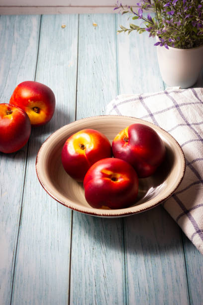 Fresh red nectarines. Wooden background.