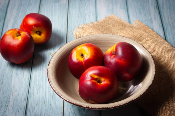 istock Fresh red nectarines. Wooden background. 1456453798