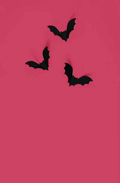 istock Cartoon halloween background black bats on trendy magenta backdrop. 1456456427