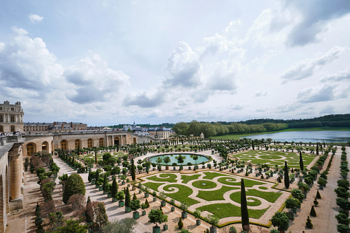 Paris, France - May, 2022:  Gardens of the famous Palace of Versailles. whole site have unique fountains, ponds, lake and landscapes built in 17th c.