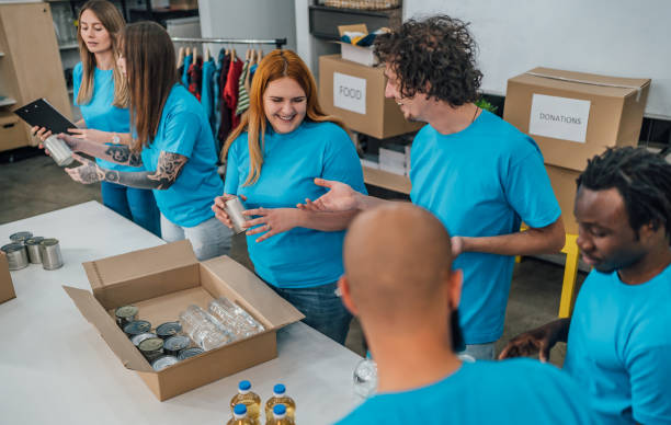 istock Volunteers packing food in donation boxes 1456460226